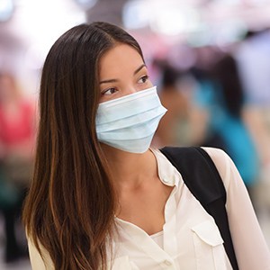 Person wearing protective mask in airport